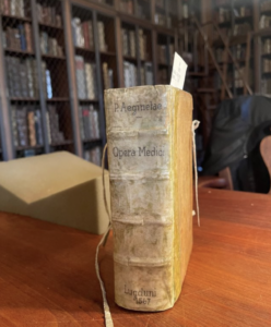 An old book about ancient egyptian medicine sits on a table